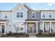 Charming townhouse featuring a covered porch and two Adirondack chairs at 728 Silo Park Dr, Wake Forest, NC 27587