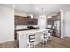 Modern kitchen features stainless steel appliances, an island with bar stool seating and gray cabinets at 728 Silo Park Dr, Wake Forest, NC 27587
