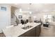 Bright, open-concept featuring kitchen with island, stainless appliances, and view to dining and living areas at 728 Silo Park Dr, Wake Forest, NC 27587