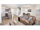 Open-concept room featuring a modern staircase, dining table, and comfortable leather furniture at 728 Silo Park Dr, Wake Forest, NC 27587