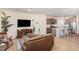 Bright, open-concept living room featuring hardwood floors, large TV, and stylish furniture at 728 Silo Park Dr, Wake Forest, NC 27587