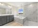 Elegant bathroom showcasing double vanity, tub, separate shower, and bright window to the outside at 89 Jumper St, Wendell, NC 27591