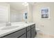 Bathroom featuring dual sink vanity, quartz countertops, and a walk-in shower at 89 Jumper St, Wendell, NC 27591