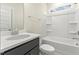 Clean, bright bathroom with a white tub/shower combo, dark vanity and a modern sink at 89 Jumper St, Wendell, NC 27591