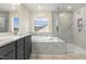 Well-lit bathroom with modern features including a tub, separate shower, and double vanity with sleek hardware at 89 Jumper St, Wendell, NC 27591