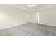 Spacious bedroom featuring neutral walls, carpet, and trim with entryways to the hallway and the Primary bathroom at 89 Jumper St, Wendell, NC 27591