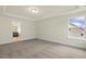 Bright bedroom featuring neutral carpet, trim, and walls with a tray ceiling and view to a Primary bathroom at 89 Jumper St, Wendell, NC 27591