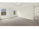 Large bedroom with neutral carpet and trim with windows providing ample natural light at 89 Jumper St, Wendell, NC 27591