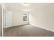 Bright bedroom with neutral carpet, window, and white trim at 89 Jumper St, Wendell, NC 27591