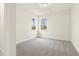 Bedroom with carpet flooring and two large windows providing ample natural light at 89 Jumper St, Wendell, NC 27591