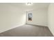 Bright bedroom with neutral walls, carpet, and a window offering natural light at 89 Jumper St, Wendell, NC 27591