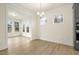 Bright dining area with large windows and modern chandelier, adjacent to the kitchen at 89 Jumper St, Wendell, NC 27591