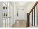 Elegant entryway featuring hardwood floors, wainscoting, a staircase, and ample natural light at 89 Jumper St, Wendell, NC 27591