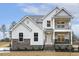 Charming two-story home boasts white siding, stone accents, covered balcony, and inviting front porch at 89 Jumper St, Wendell, NC 27591