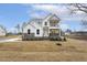 Beautiful two-story home with white siding, stone accents, a covered balcony, and manicured lawn at 89 Jumper St, Wendell, NC 27591