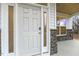 Close-up of a stylish white front door with glass sidelights and stone detailing at 89 Jumper St, Wendell, NC 27591