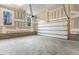 Spacious garage with a concrete floor, block foundation, and a roll-up garage door at 89 Jumper St, Wendell, NC 27591