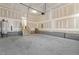 Large garage space featuring an unfinished interior, concrete floor, stairs and plenty of potential at 89 Jumper St, Wendell, NC 27591