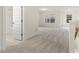 Carpeted hallway with natural light and access to the bathroom and other rooms at 89 Jumper St, Wendell, NC 27591