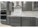 Kitchen featuring gray cabinets and stainless steel appliances at 89 Jumper St, Wendell, NC 27591