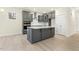 Modern kitchen with gray cabinets, white countertops, and stainless steel appliances at 89 Jumper St, Wendell, NC 27591