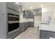 Kitchen featuring gray cabinets, a built-in oven, and a large island at 89 Jumper St, Wendell, NC 27591