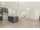Kitchen island with sink and dishwasher, open to the living area with wood flooring at 89 Jumper St, Wendell, NC 27591