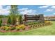 Landscaped community entrance featuring a stone sign and well-manicured lawn at 900 Canis Minor Rd, Wendell, NC 27591
