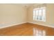 Spacious bedroom with hardwood floors and large window with shutters at 992 Blue Bird Ln, Wake Forest, NC 27587