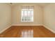 Spacious bedroom with hardwood floors and large window with shutters at 992 Blue Bird Ln, Wake Forest, NC 27587