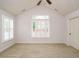 Bright bedroom with carpeted floors, ceiling fan, and plantation shutters at 992 Blue Bird Ln, Wake Forest, NC 27587