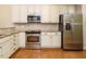 Kitchen boasts stainless steel appliances and white cabinets at 992 Blue Bird Ln, Wake Forest, NC 27587