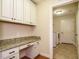 Laundry room with built-in workspace and access to additional rooms at 992 Blue Bird Ln, Wake Forest, NC 27587