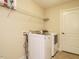 Bright laundry room features washer, dryer, and ample shelving at 992 Blue Bird Ln, Wake Forest, NC 27587