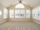 Bright sunroom featuring multiple windows with plantation shutters and vaulted ceiling at 992 Blue Bird Ln, Wake Forest, NC 27587