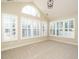 Sunroom with vaulted ceiling, large windows, and plantation shutters at 992 Blue Bird Ln, Wake Forest, NC 27587