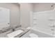 Bright bathroom featuring granite countertop, toilet and a shower/tub combo at 107 Wilderness Ct, Mebane, NC 27302