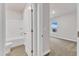 Bathroom featuring tub, shower, toilet, white door, and a bedroom view at 107 Wilderness Ct, Mebane, NC 27302