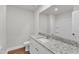 All white bathroom boasts a granite countertop, toilet, large mirror, and a tub/shower combo at 107 Wilderness Ct, Mebane, NC 27302