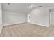 Bright bedroom featuring neutral carpet, high ceilings, and an open ensuite bathroom at 107 Wilderness Ct, Mebane, NC 27302