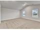 Bright bedroom featuring neutral carpet, high ceilings, and ample windows at 107 Wilderness Ct, Mebane, NC 27302