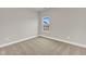 Neutral bedroom with carpet, window, base molding, and light gray walls at 107 Wilderness Ct, Mebane, NC 27302