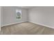 Bedroom with neutral carpet, gray walls, window, and white baseboards at 107 Wilderness Ct, Mebane, NC 27302