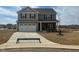 Beautiful new home with stone accents, gray siding, and two-car garage in a Gathering-friendly neighborhood at 107 Wilderness Ct, Mebane, NC 27302