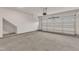 Clean two-car garage with concrete floor, white walls, and overhead door at 107 Wilderness Ct, Mebane, NC 27302