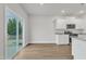 Bright kitchen with modern white cabinets, stainless steel appliances, and a sliding door to the backyard at 107 Wilderness Ct, Mebane, NC 27302