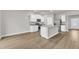 Modern kitchen with white cabinets, stainless steel appliances, and a large center island at 107 Wilderness Ct, Mebane, NC 27302