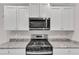 Modern kitchen featuring stainless steel appliances and granite countertops at 107 Wilderness Ct, Mebane, NC 27302