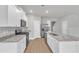 Modern white kitchen with stainless steel appliances, granite counters, and central island at 107 Wilderness Ct, Mebane, NC 27302
