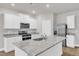 Bright kitchen with white cabinets, granite countertops, and stainless steel appliances at 107 Wilderness Ct, Mebane, NC 27302